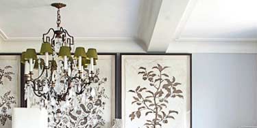 <a href="http://www.ralphlaurenpaint" target="blank">RalphLauren Paint</a>'s Polaris gives the room a luminous quality against which atriptych of oversized gilded botanicals and a glittering, antique-inspiredchandelier really sparkle.