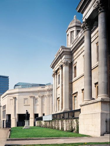 Distant facade of Sainsbury Wing of London's National Gallery acknowledges the older structure in the foreground by using modernized faux columns and filled-in windows
