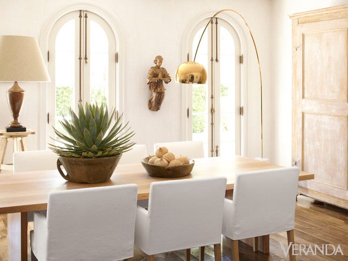 Modern French Country dining room by Pamela Pierce. White slipcovered archairs with custom white oak table and modern lighting. #modern #frenchcountry #diningroom #pamelapierce