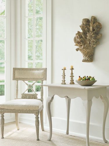 Swedish chair, c.1800, in muslin. Dutch 18th-c. table. Antique French sculpture on wall. Oushak rug, c.1920. 
