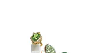 CLOCKWISE FROM TOP LEFT: Donald Huber's Large Oval Wave ring with peridot and diamonds in 18k gold. Antique Portuguese 18th-c. chrysoberyl ring from Siegelson. Tamara Comolli's 19.38-carat oval cabochon green tourmaline ring in 18k gold. Sharon Khazzam's Octopus ring with faceted oval peridot, orange and yellow sapphires and yellow diamonds in 18k gold. Russell Trusso's 18-carat peridot Dome ring with diamonds in 18k gold. Judith Ripka's pavé Cushion ring with green sapphires, tsavorite, peridot and diamonds in 18k gold.
