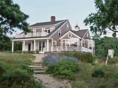 On the site of her family's longtime beach cottage on Cape Cod, Meredith Hutchison designed a larger structure with the same spirit. Two upstairs master bedrooms face bay. <i>Far right</i>, outdoor shower.