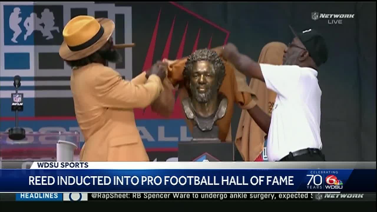 Former NFL player Ed Reed poses with a bust of himself during the induction  ceremony at the Pro Football Hall of Fame, Saturday, Aug. 3, 2019, in  Canton, Ohio. (AP Photo/Ron Schwane