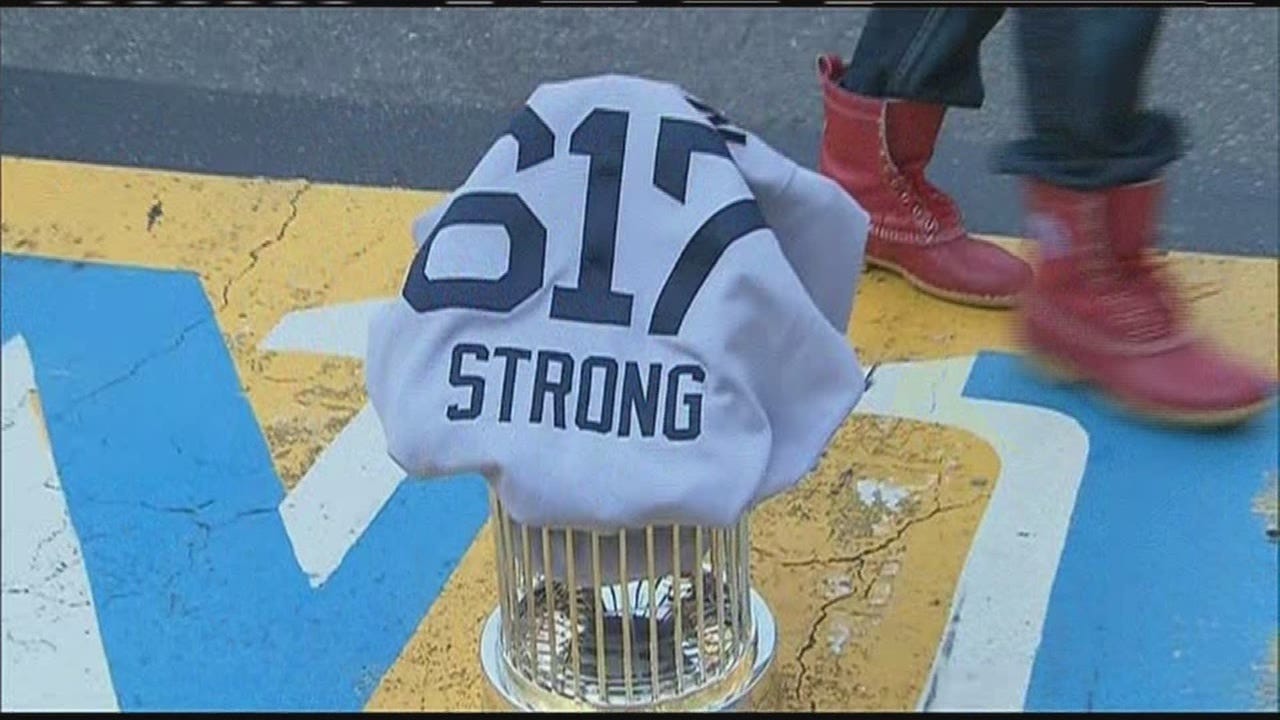 Red Sox place World Series trophy, covered in a 617 Boston Strong