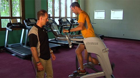 mature woman exercising on elliptical machine