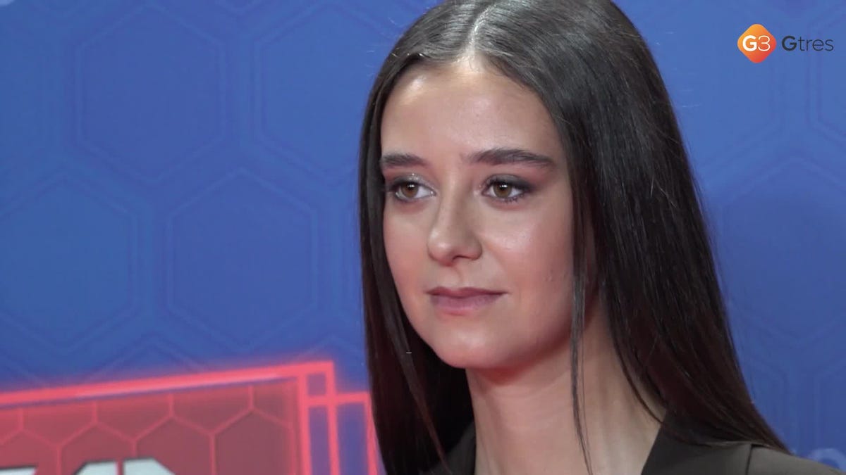 a female participant in a game show or event interacting with a host