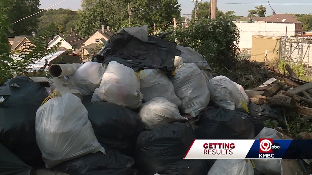 Trash pile growing in alley behind Historic Northeast Kansas City home