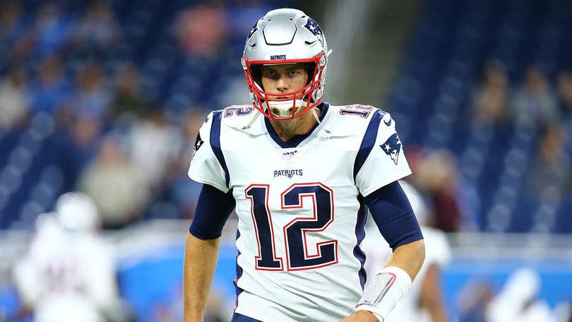 Tom Brady cuts some of Chase Winovich's hair on the sideline