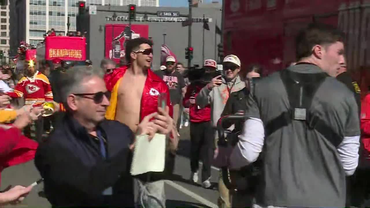 Brittany Mahomes grabs Chiefs flag as Patrick Mahomes shows off the 'dad bod' on the parade route