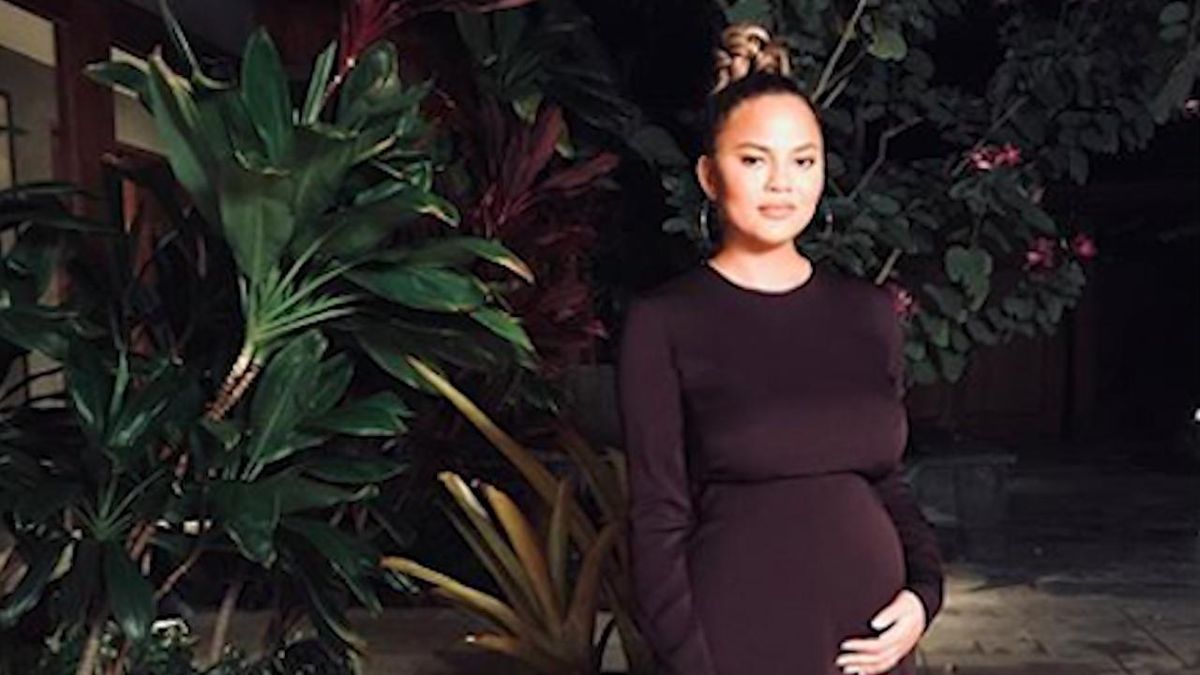 preview for Crissy Teigen Dresses Up Her Baby Bump in Curve-Hugging Gown