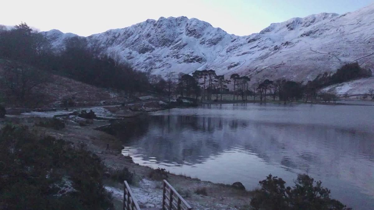 preview for Snowy hills reflect beautifully on Lake Buttermere in the Lake District