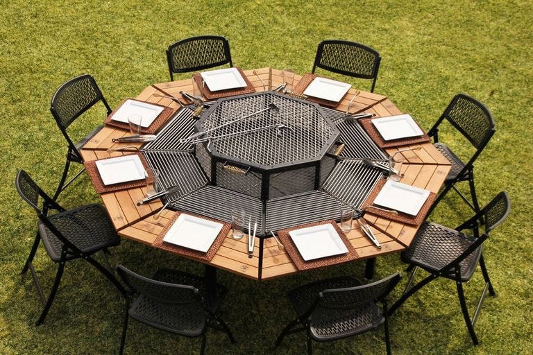 preview for This Tricked-Out Fire Pit Is A Grill And Dining Table In One
