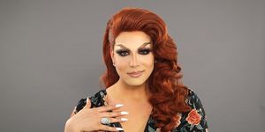 alexis michelle smiles into the camera in full drag