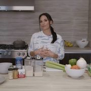 heidi d'amelio stands in her kitchen with a bunch of ingredient