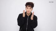 jason wong stands against a plain white background he is wear gin a black zip up hoodie