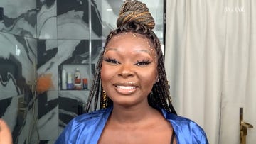 shalom blac sits in her bathroom in full makeup, wearing a bathrobe