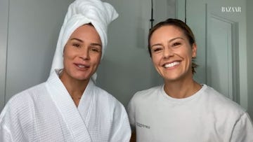 ashlyn harris  ali krieger stand next to each other in a large bathroom