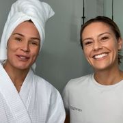 ashlyn harris  ali krieger stand next to each other in a large bathroom