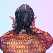 a young black woman shows off her double x stitch braids