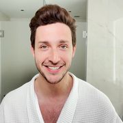 dr mike smiles in his bathroom wearing a bath robe