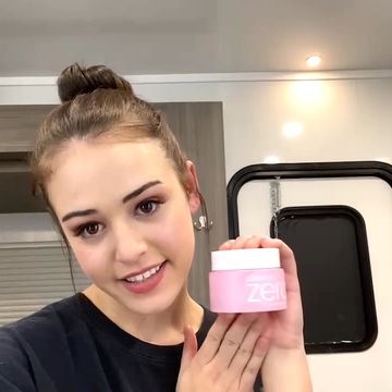 kaylee bryant holds up a makeup product