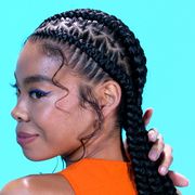 a young black woman shows off her starburst stitch braids
