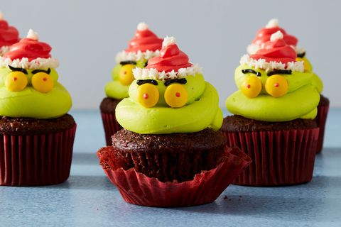 kranky cupcakes, aka grinch heads with santa hats on top of chocolate cupcakes