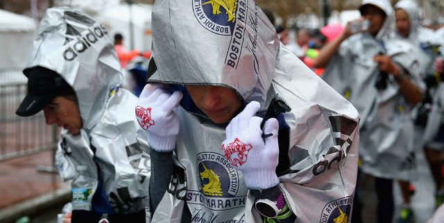runner warming up after cold and rainy race