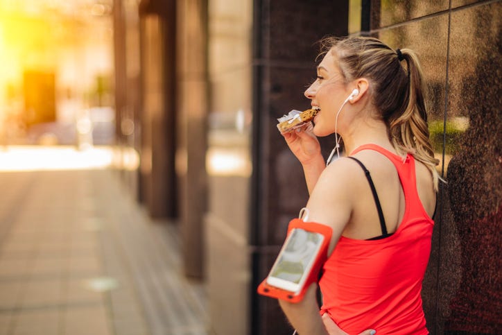 the young woman couldn't resist the sweet temptation, she excitedly bit into a sweet donut and gave preference to healthy vegetables