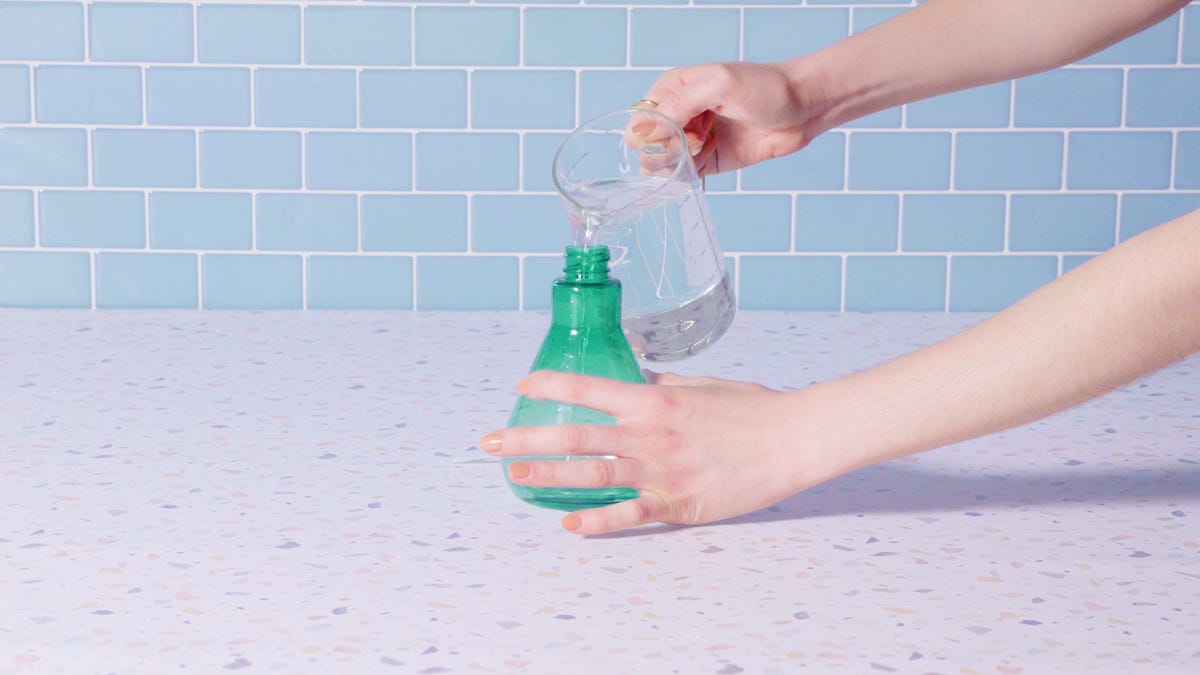 hand holding sponge, washing dishes