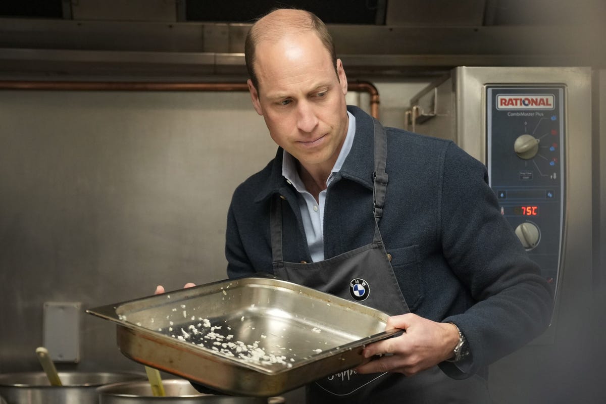 el principe de gales con una bandeja en una cocina