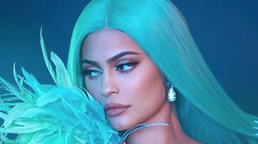 Kylie Jenner Wears an LV Du-Rag, Cavalli Snake Pants, and Black Suede Pumps  in Glosses Lip Kit Commercial