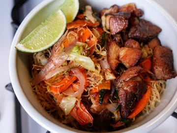 pancit bihon with pork, onions, carrots, and citrus