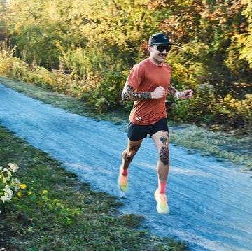 a runner on a gravel path along a canal a runner on a gravel path along a canal