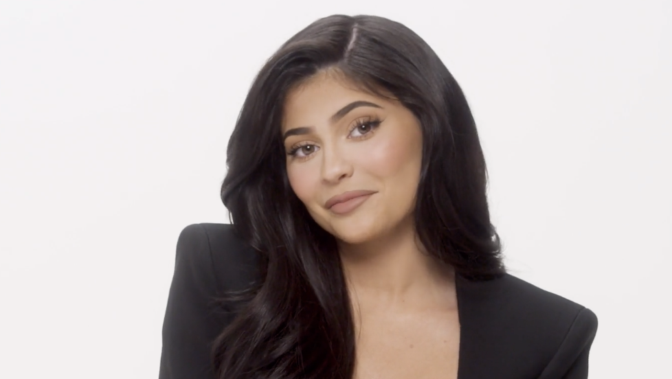 Kylie Jenner Wears an LV Du-Rag, Cavalli Snake Pants, and Black Suede Pumps  in Glosses Lip Kit Commercial