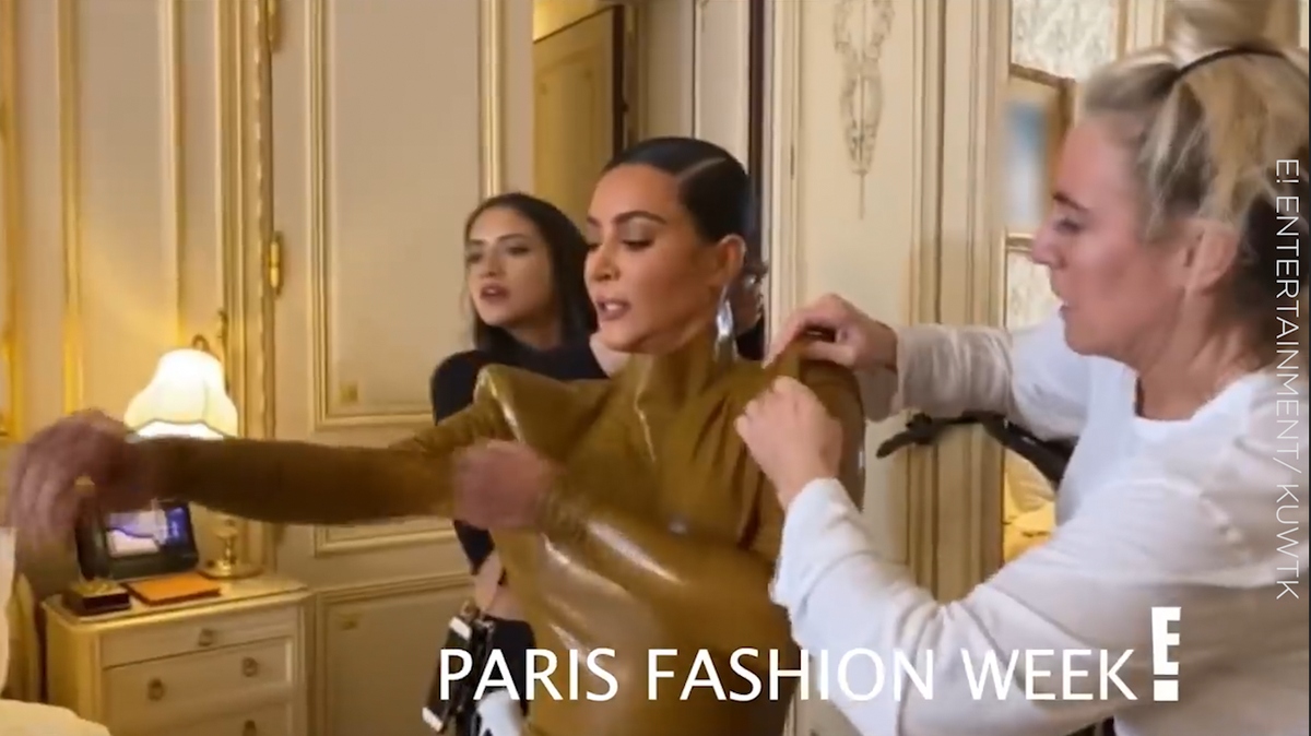 preview for Watch Kim Kardashian squeezing into a latex outfit for fashion week