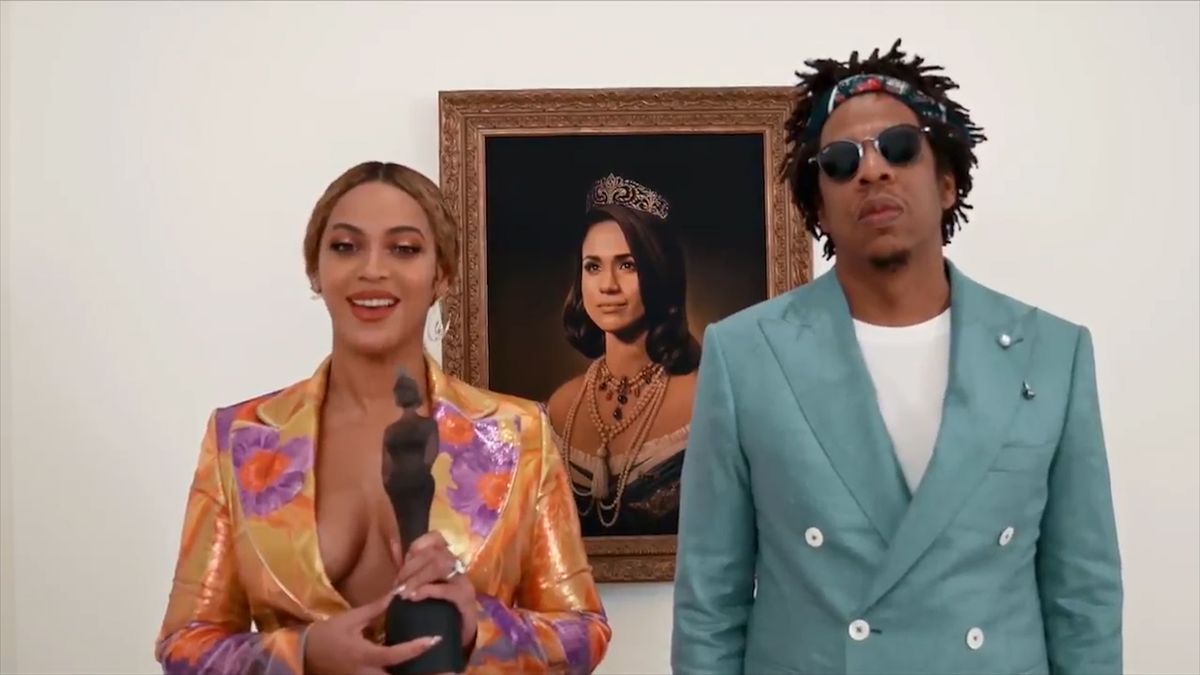 preview for Beyonce and Jay-Z accept BRIT Award in front of Meghan Markle painting