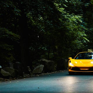 Ferrari F8 Spider a yellow ferrari f8 spider on a dark forest road