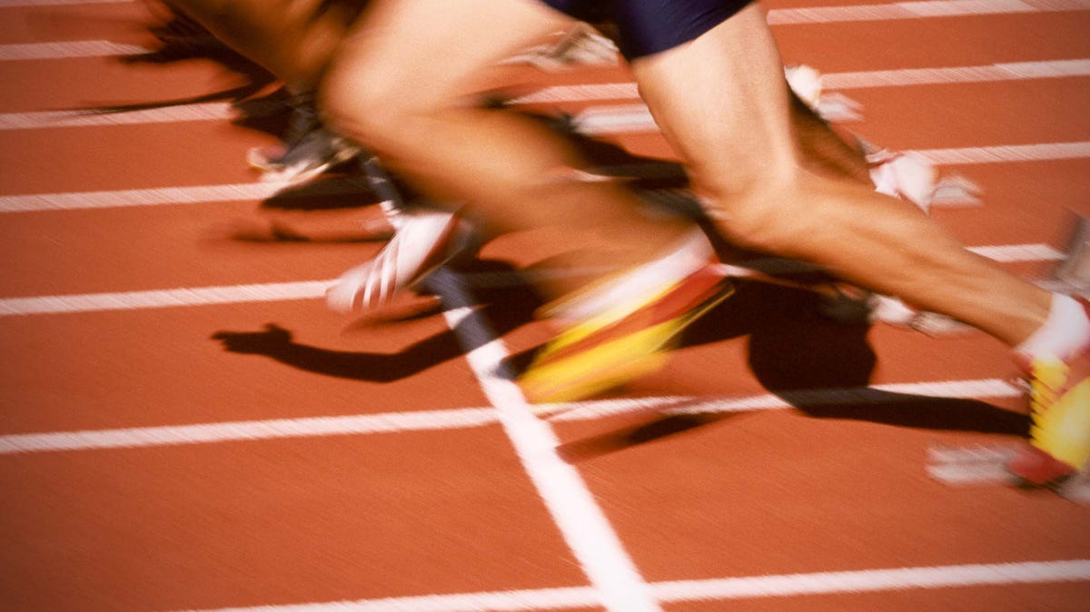 african woman running on racetrack