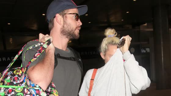 preview for Liam Hemsworth and Miley Cyrus Hold Hands as They Land in LA