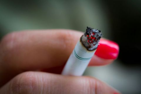 Close-Up Of Hand Holding Cigarette