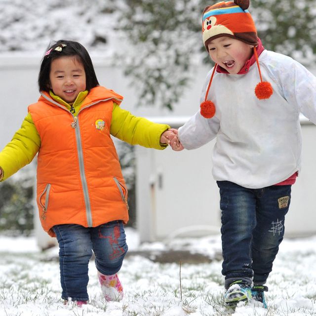 Three children play in snow on January 21, 2016 in Nanjing, Jiangsu Province of China. Jiangsu Province encountered heavy snow in south China with the temperature lowering sharply 9 degrees Celsius to 11 degrees Celsius on weekends.