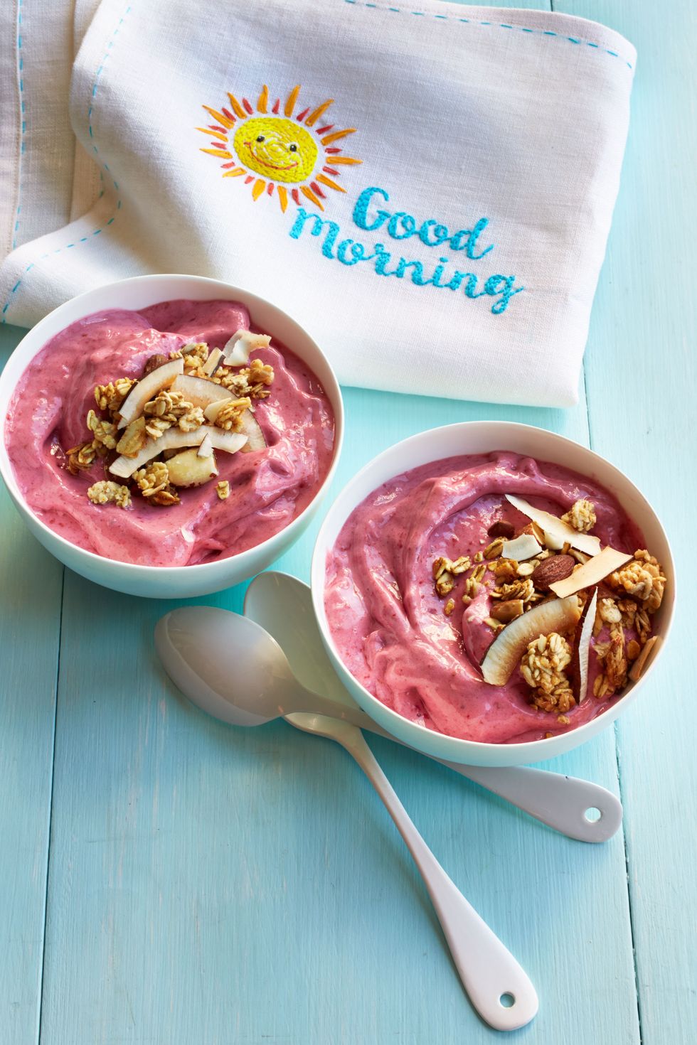 raspberry smoothie bowl topped with granola and shaved coconut