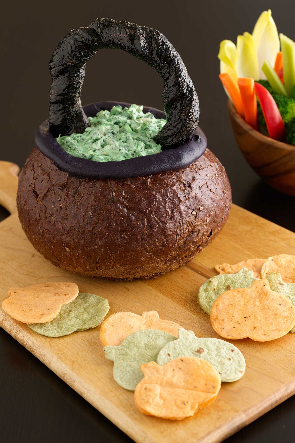 halloween appetizers spinach dip in a bread bowl cauldron