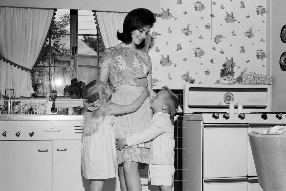 Photograph, Retro style, Standing, Room, Homemaker, Snapshot, Kitchen, Black-and-white, Leg, Dress, 