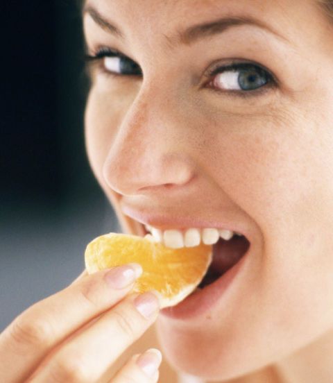 woman eating an orange