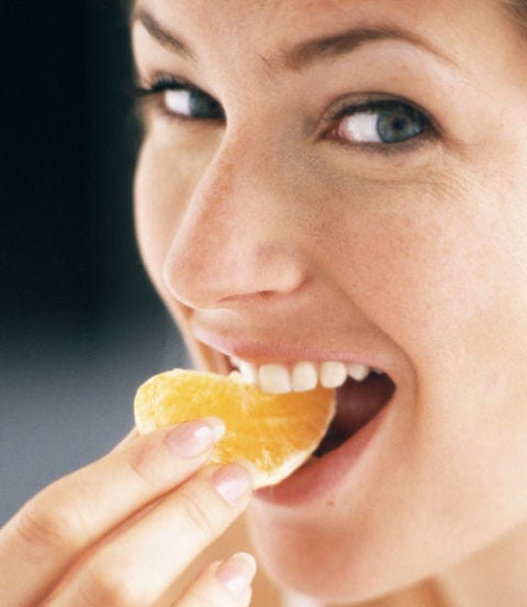 Peel an Orange and Eat It woman eating an orange