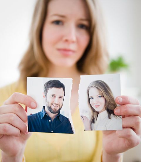 woman holding torn photograph