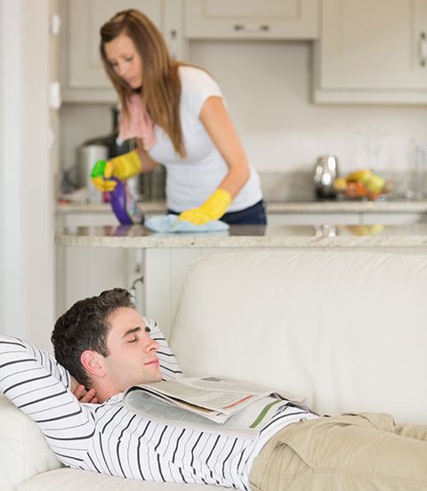 woman cleaning while man sleeping