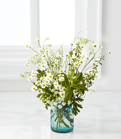 Mellow Yellow <p>TIME: 25 minutes<br /> <strong>Materials</strong></p> <p>Floral shears<br /> Small white cup or vase<br /> Geranium<br /> Mint<br /> Queen Anne's lace<br /> Sunflowers<br /> Chamomile<br /> Nigella</p> <p><strong>Directions</strong></p> <p>1. Use the floral shears to trim the bottom of a few geranium stems. Cluster them at the base of the vase, allowing the leaves to drape over the sides. <br /> 3. Trim about two or three sprigs of mint and tuck them in on different sides of the arrangement, filling empty areas between the geranium leaves. <br /> 4. Insert about three or four trimmed stems of Queen Anne's lace at the far edges of the vase, varying the height and choosing pieces that have already bloomed, as well as ones that are just budding. <br /> 5. Select seven or eight sunflowers and trim to different heights, keeping some the same length as the Queen Anne's lace and the others a bit taller. Group a few on one side of the vase, and turn the faces of the flowers in slightly different directions for a less formal feel. Place one opposite the group to create a low, oval shape. If the flower heads are too heavy to stand on their own, lean them against the hardy mint sprigs for support.<br /> 6. Cut a small bunch of chamomile and place just off center. Add some sparser pieces to break up overly green patches. <br /> 7. Select a handful of wispy nigella and cut them just longer than the Queen Anne's lace, adding to fill in any last gaps and complete the shape.</p> <p><strong>DIY Tips:</strong></p> <p>1. Try a footed, opaque vessel for an interesting bouquet silhouette. Bonus: Stems won't distract.</p> <p>2. To create whimsy, play with scale, like these small chamomile blossoms and larger sunflowers.</p> <p>3. Position hardy greenery (here, mint sprigs) to hold up heavy flower heads.</p>